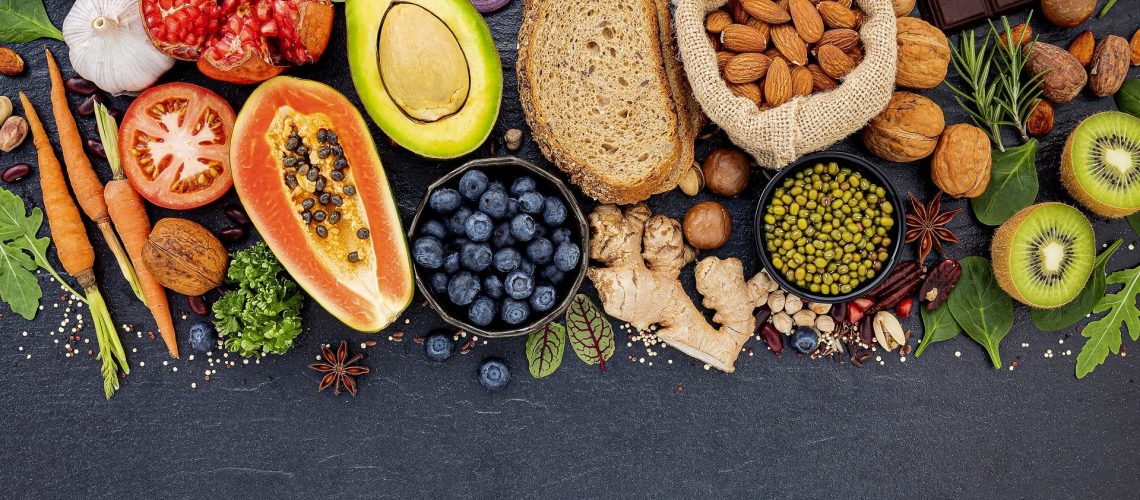 Ingredients for the healthy foods selection. The concept of healthy food set up on dark stone background.